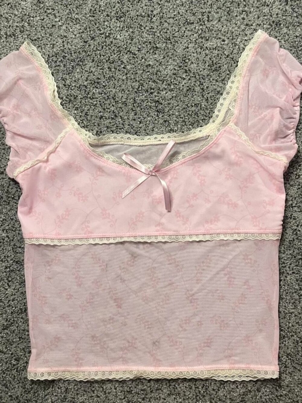 Pink lace babydoll crop top with subtle floral print